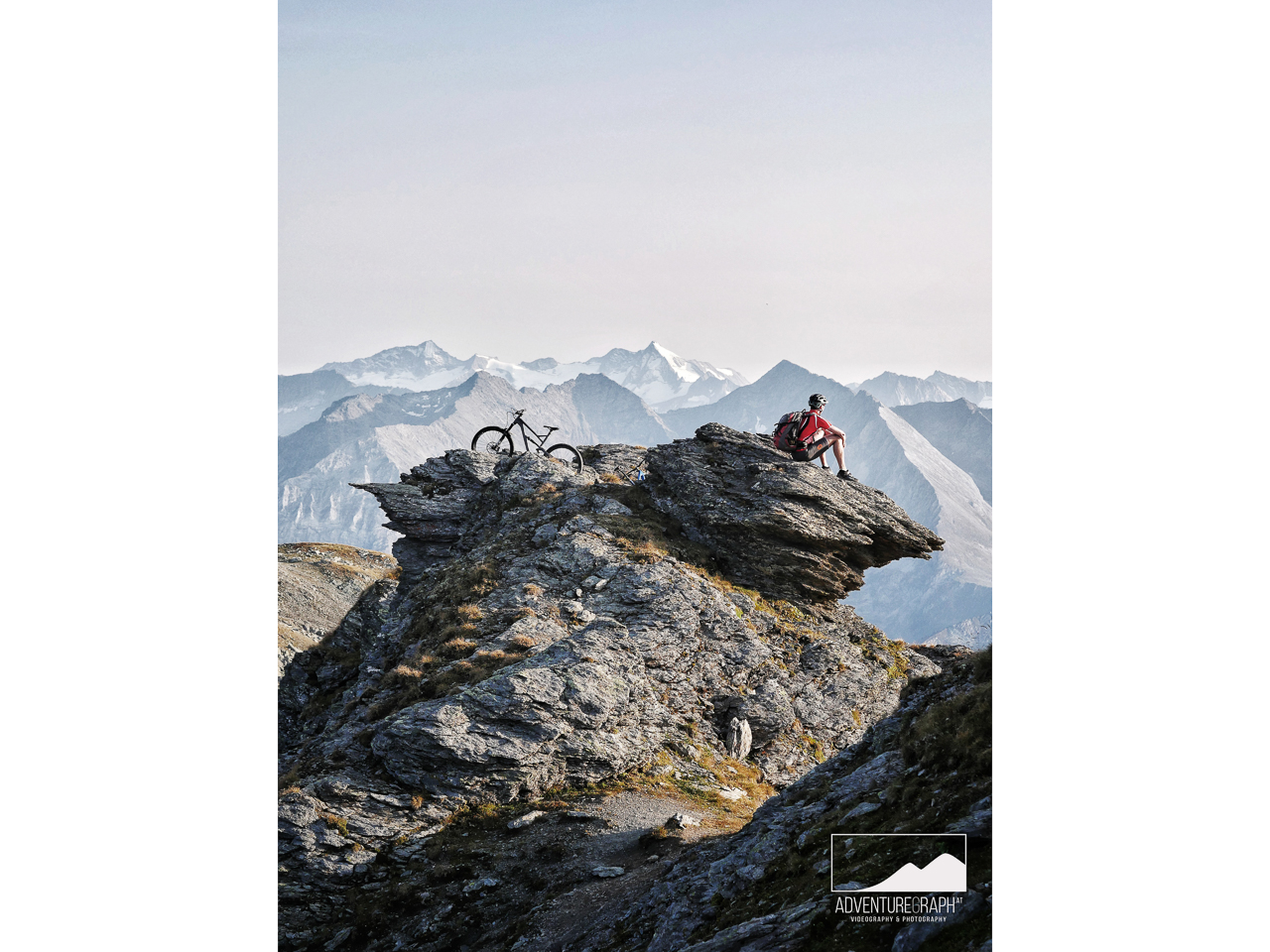 High Alpine mountainbike enduro tour at peak with landscape view onto Zillertal.